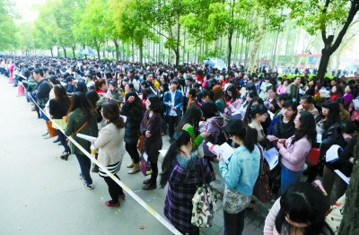 昨天,参加2013武汉事业单位招聘考试的考生站在警戒线外准备进场。记者金振强 摄